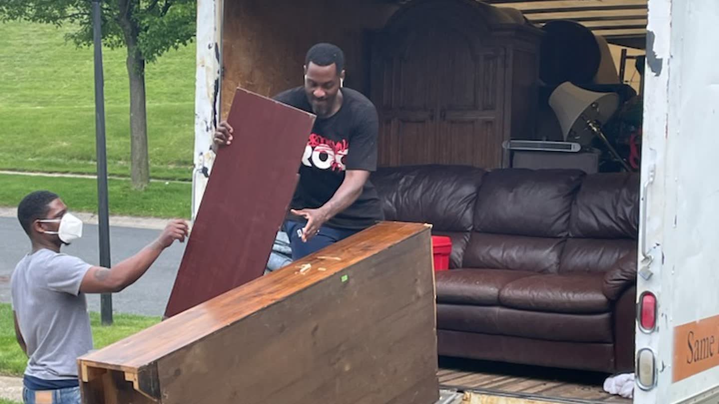 Rich Brothers crew loading furniture into a box truck on a junk removal job in Maryland