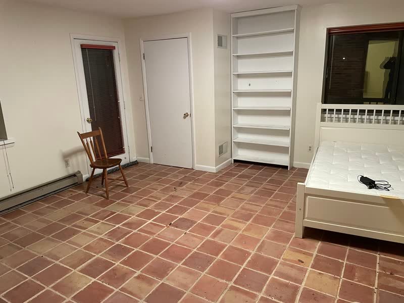 Empty tiled room with bare shelving after a completed Rich Brothers property cleanout