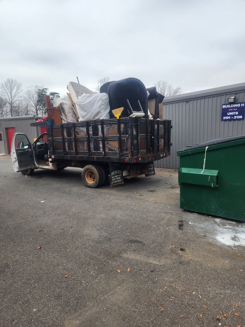 Rich Brothers dump truck loaded with mattresses and furniture at a disposal and recycling site